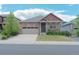 Charming single-Gathering home featuring a stone facade, well-maintained lawn, and a two-car garage at 5741 Echo Park Cir, Castle Rock, CO 80104