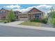 Charming single-Gathering home featuring a stone facade, well-maintained lawn, and a two-car garage at 5741 Echo Park Cir, Castle Rock, CO 80104
