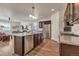 Modern kitchen with stainless steel appliances, granite countertops, and a large island with a sink at 5741 Echo Park Cir, Castle Rock, CO 80104