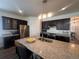Spacious kitchen featuring dark cabinets, granite countertops, stainless steel appliances and large island at 5741 Echo Park Cir, Castle Rock, CO 80104