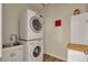 Efficient laundry room with a stacked washer and dryer and a utility sink at 5741 Echo Park Cir, Castle Rock, CO 80104