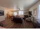 Spacious living room and dining area featuring hardwood floors, modern lighting, and comfortable couches at 5741 Echo Park Cir, Castle Rock, CO 80104
