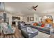 Open-concept living room with hardwood floors, comfortable seating, and a view of the kitchen and dining area at 5741 Echo Park Cir, Castle Rock, CO 80104