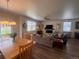Open-concept living room and dining area with hardwood floors, modern lighting, and comfortable seating at 5741 Echo Park Cir, Castle Rock, CO 80104