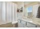 Functional bathroom with a shower-tub combo, stylish vanity, and good natural light at 8078 S Yantley Ct, Aurora, CO 80016