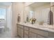 Bright bathroom featuring dual sinks, a large mirror, and natural light at 8078 S Yantley Ct, Aurora, CO 80016