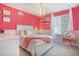Charming bedroom with pink walls, a chandelier, and a whimsical hanging chair at 8078 S Yantley Ct, Aurora, CO 80016