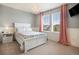 Serene bedroom with gray walls, white wainscoting, and large windows for natural light at 8078 S Yantley Ct, Aurora, CO 80016