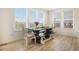 Bright dining area featuring a modern table setting with natural light streaming through large windows at 8078 S Yantley Ct, Aurora, CO 80016
