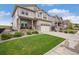 Beautiful two-story home with stone accents, a manicured lawn, and a two-car garage, offering great curb appeal at 8078 S Yantley Ct, Aurora, CO 80016