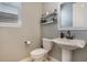 Cozy half bathroom with a pedestal sink, modern fixtures, and a clean, minimalist design at 8078 S Yantley Ct, Aurora, CO 80016
