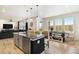 Spacious open kitchen featuring a large island with seating, stainless steel appliances, and seamless flow into the living area at 8078 S Yantley Ct, Aurora, CO 80016