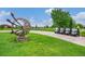 Beautifully landscaped community area with a sculpture, golf carts, and a scenic green space at 8078 S Yantley Ct, Aurora, CO 80016