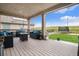 Inviting covered patio features stylish seating, string lights, and a beautiful view of the backyard at 8078 S Yantley Ct, Aurora, CO 80016