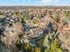 Aerial view of home in a neighborhood with mature trees with views of the city at 1998 S Harlan Ct, Lakewood, CO 80227