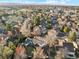 Aerial view of a neighborhood showcasing mature trees, well-maintained homes, and a peaceful residential setting at 1998 S Harlan Ct, Lakewood, CO 80227