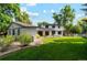 Spacious backyard features a detached flex space and a patio, perfect for outdoor entertaining at 1998 S Harlan Ct, Lakewood, CO 80227