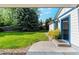 Backyard features lush green lawn, mature trees, and outdoor access at 1998 S Harlan Ct, Lakewood, CO 80227