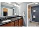Bathroom featuring a double vanity with a black countertop and modern fixtures at 1998 S Harlan Ct, Lakewood, CO 80227