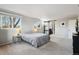 Spacious bedroom featuring large windows, soft carpet, and ensuite bathroom access at 1998 S Harlan Ct, Lakewood, CO 80227
