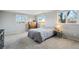 Bright bedroom with large windows and soft carpet. The room is painted in neutral colors at 1998 S Harlan Ct, Lakewood, CO 80227