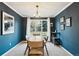 Stylish dining room features dark blue walls, contemporary light fixture, and a large window at 1998 S Harlan Ct, Lakewood, CO 80227