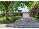 Charming two-story home features a manicured lawn, brick accents, and an attached two-car garage at 1998 S Harlan Ct, Lakewood, CO 80227