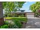 Charming two-story home features a manicured lawn, brick accents, and an attached two-car garage at 1998 S Harlan Ct, Lakewood, CO 80227