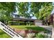 Charming two-story home features a manicured lawn, brick accents, and an attached two-car garage at 1998 S Harlan Ct, Lakewood, CO 80227