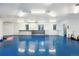 Bright garage with blue epoxy floor and cabinets, perfect for a workshop or hobby space at 1998 S Harlan Ct, Lakewood, CO 80227