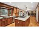 Large kitchen with granite counters, wood cabinets, stainless appliances, and open floor plan at 1998 S Harlan Ct, Lakewood, CO 80227
