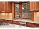 Custom kitchen with granite counters, stainless appliances, and bright bay window over sink at 1998 S Harlan Ct, Lakewood, CO 80227