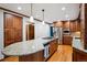 Open kitchen with large granite island and custom wood cabinets, stainless appliances at 1998 S Harlan Ct, Lakewood, CO 80227