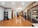 Open concept living space with hardwood floors, leading to kitchen and outdoor patio at 1998 S Harlan Ct, Lakewood, CO 80227