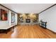Bright living room with hardwood floors and a stone fireplace, natural light through windows at 1998 S Harlan Ct, Lakewood, CO 80227