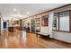 Open concept living space with hardwood floors, adjoined to kitchen, and backyard access at 1998 S Harlan Ct, Lakewood, CO 80227