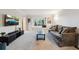 Bright living room with a large window, comfortable seating, and a modern entertainment center at 1998 S Harlan Ct, Lakewood, CO 80227
