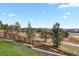 Backyard view featuring a retaining wall, green space, fence, and neighborhood views at 20132 Spruce Point Pl, Parker, CO 80134