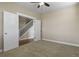 This bedroom features neutral carpeting, light-colored walls, and a staircase visible through the open doorway at 20132 Spruce Point Pl, Parker, CO 80134