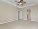 Spacious bedroom with neutral carpet, light-colored walls, tray ceilings, and ceiling fan at 20132 Spruce Point Pl, Parker, CO 80134