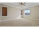 Spacious bedroom with neutral carpet, light walls, tray ceilings, and natural light from windows at 20132 Spruce Point Pl, Parker, CO 80134