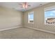 Bedroom featuring neutral carpet, modern ceiling fan, and windows with exterior views at 20132 Spruce Point Pl, Parker, CO 80134