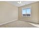 Bright bedroom with neutral carpet, modern ceiling fan, and expansive window overlooking city views at 20132 Spruce Point Pl, Parker, CO 80134