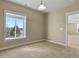 Bright bedroom with a large window offering neighborhood views and neutral-toned carpet at 20132 Spruce Point Pl, Parker, CO 80134