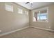 This bedroom is cozy with neutral carpet, and has an abundance of natural light from its window at 20132 Spruce Point Pl, Parker, CO 80134