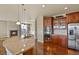 Modern kitchen featuring stainless steel appliances, granite countertops, and wood cabinetry at 20132 Spruce Point Pl, Parker, CO 80134