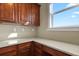 This walk-in pantry features wood cabinets, light countertops and a view from the window at 20132 Spruce Point Pl, Parker, CO 80134