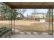 Spacious backyard enclosed by a wooden fence with a covered patio area at 3765 S Depew St, Denver, CO 80235