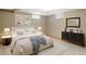 Bedroom showcasing a comfortable bed with a dresser and soft natural lighting at 3765 S Depew St, Denver, CO 80235