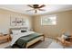 Comfortable bedroom with natural light, ceiling fan, and neutral decor, with a calming ambiance at 3765 S Depew St, Denver, CO 80235